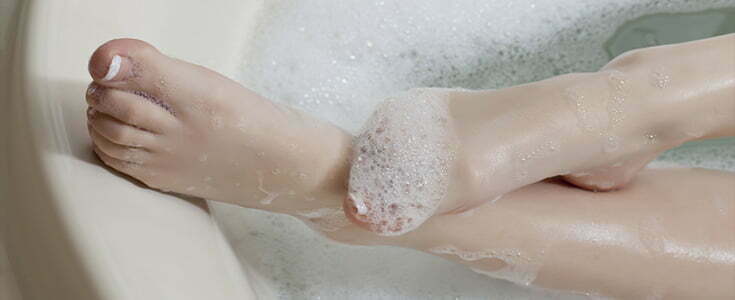 feet in hot bath with bubbles