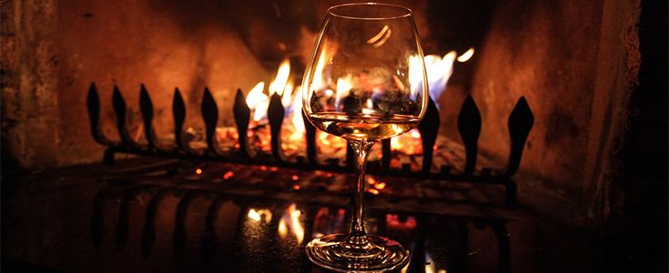 Drinking wine by the fire